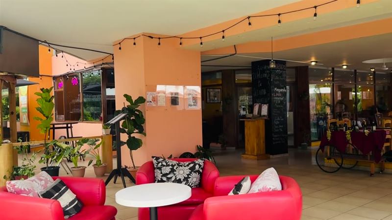 Lounge real de La Divina Commedia — sillones rojos y luces cálidas