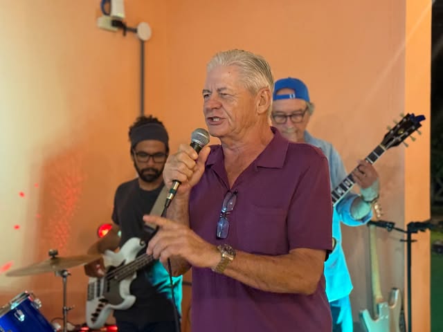 Real photo of the lead singer performing up close with the band at La Divina Commedia Coronado